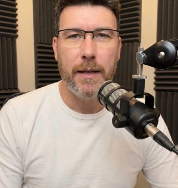 Ben behind mic white shirt
